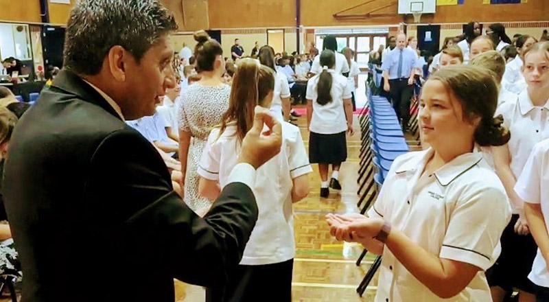 Principal of Emmaus Catholic College Kemps Creek, Robert Nastasi, interacting with a student