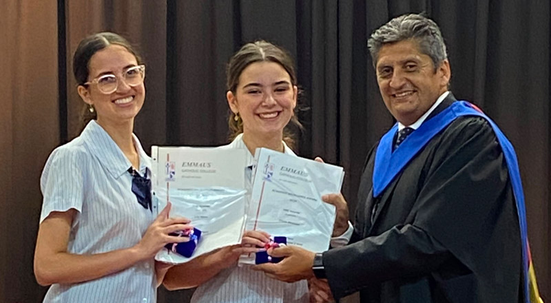 Robert Nastasi, Principal of Emmaus Catholic College Kemps Creek, presenting awards to two students
