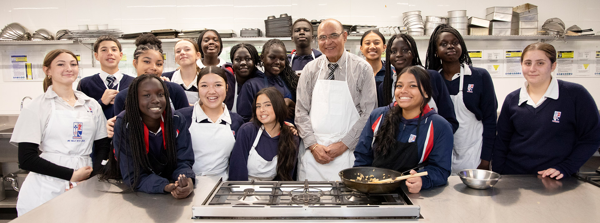 Emmaus Catholic College Kemps Creek teacher with students in the kitchen