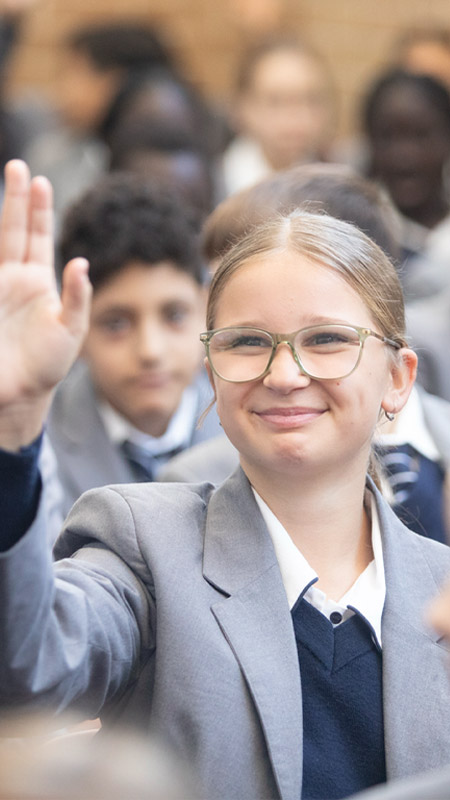 Emmaus Catholic College student raising their hand during assembly
