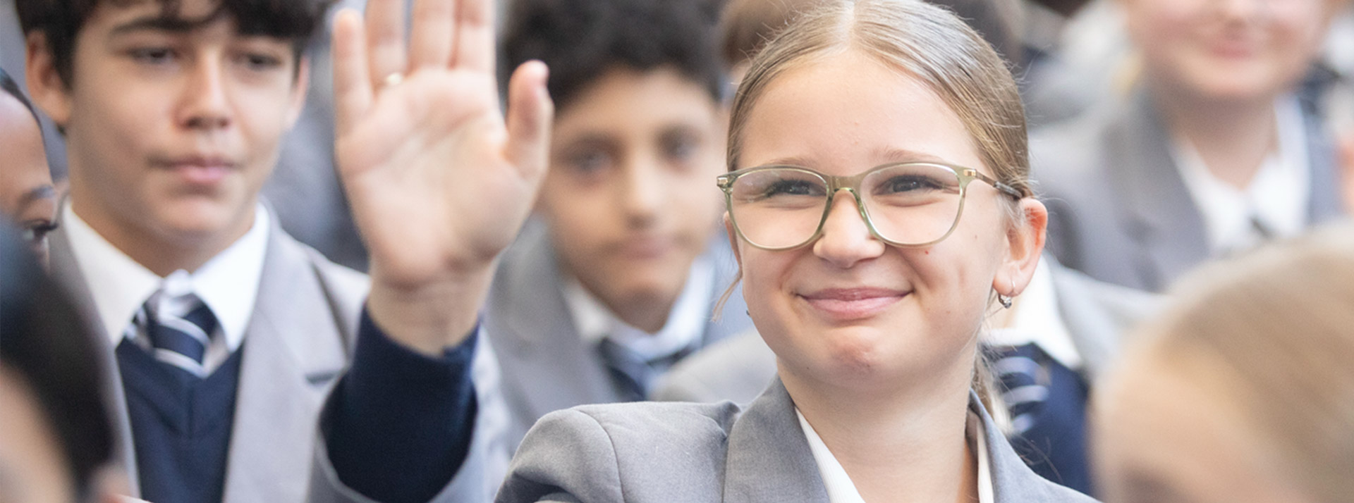 Emmaus Catholic College student raising their hand during assembly