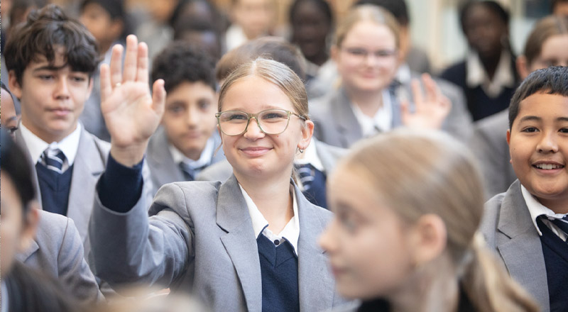 Emmaus Catholic College student raising their hand during assembly