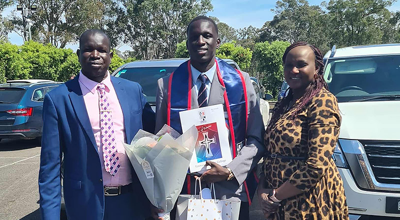 Biar, pictured with his family, at graduation